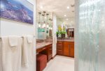 The master bathroom features two vanities and a large walk in shower